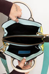 Handbag with a visible interior and strap, held by a person.