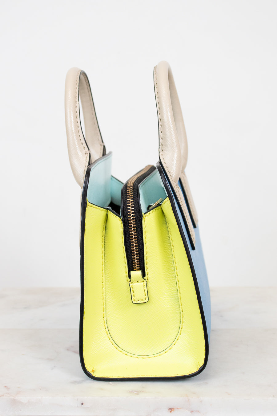 Colorful handbag with a zipper on a light background