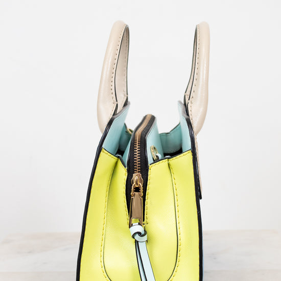 Yellow handbag with a gold zipper on a white background