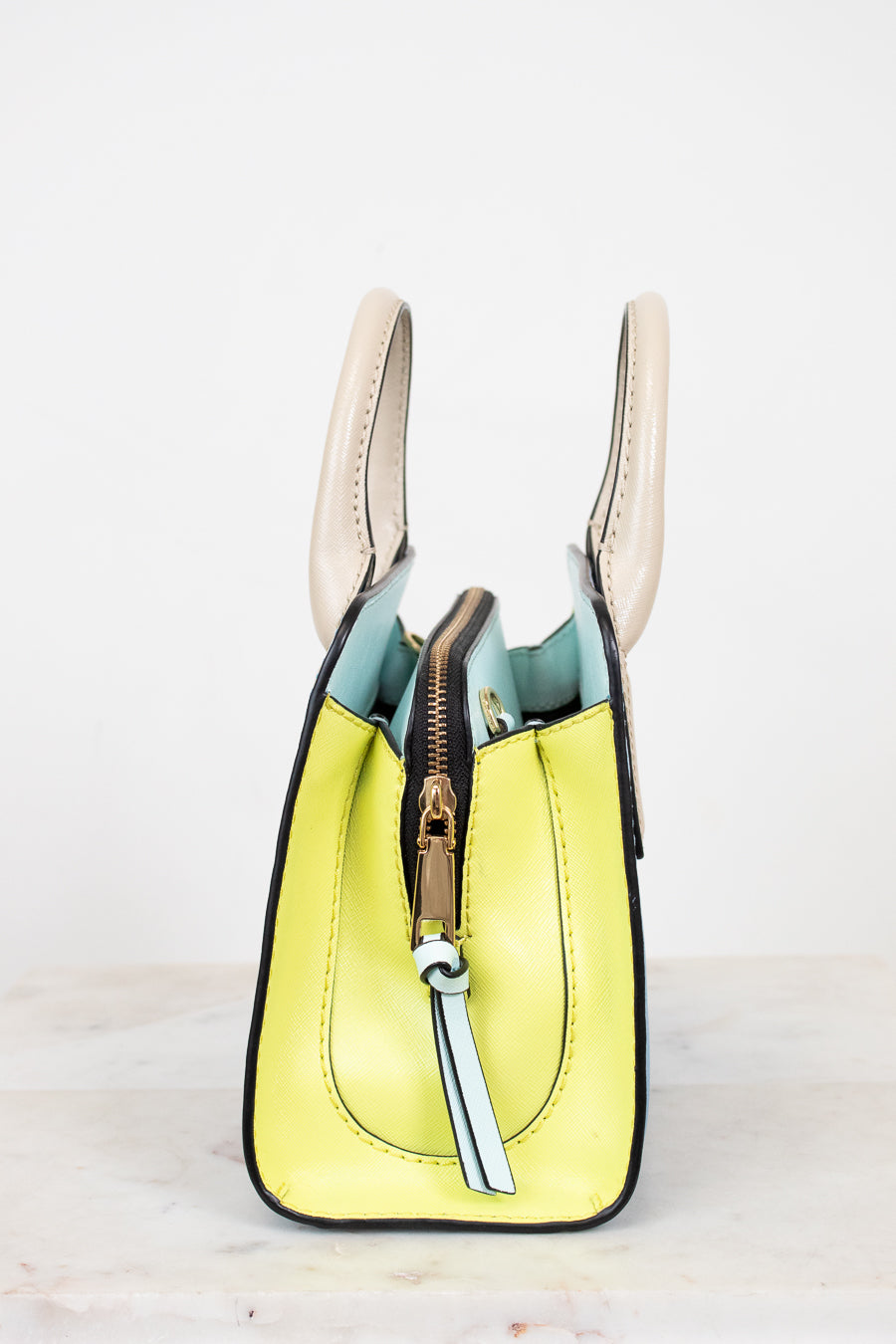 Yellow handbag with a gold zipper on a white background