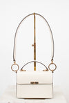 White handbag with gold accents on a white background