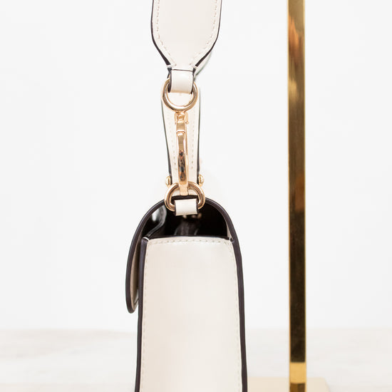 Side view of white shoulder bag on white background