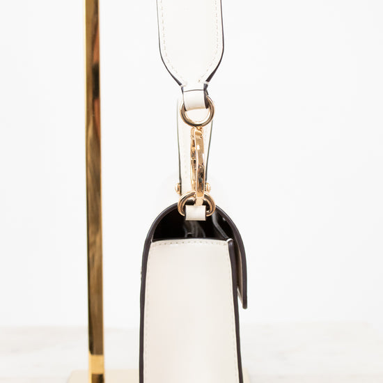 Side view of white shoulder bag on white background