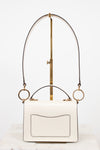 White handbag with gold accents on a white background