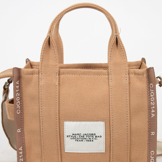 Brown handbag with visible branding on a white background