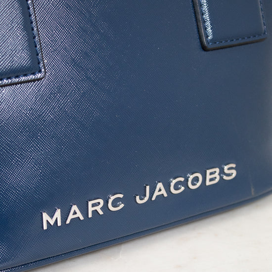 Blue handbag with 'Marc Jacobs' logo on a light background