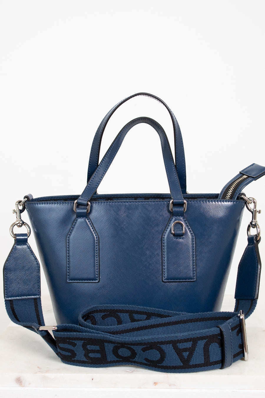 Blue handbag with a visible brand logo on a white background