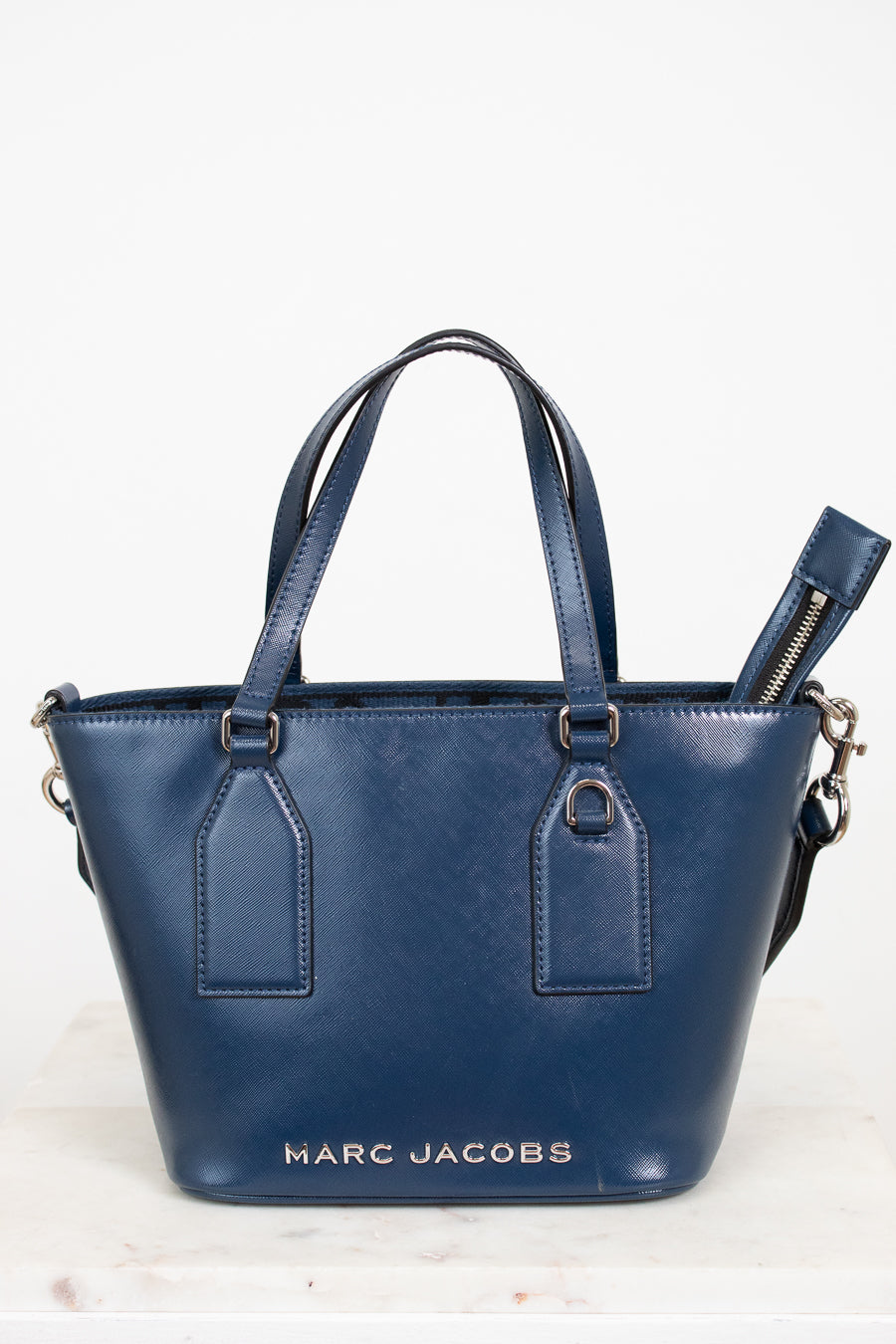Blue handbag with 'Marc Jacobs' branding on a white background
