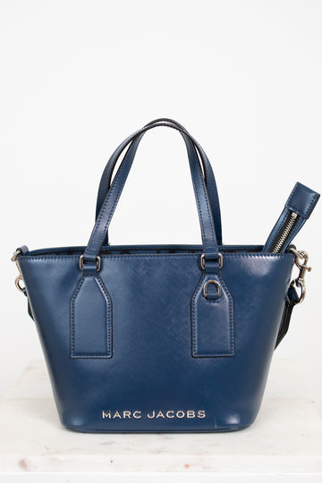 Blue handbag with 'Marc Jacobs' branding on a white background