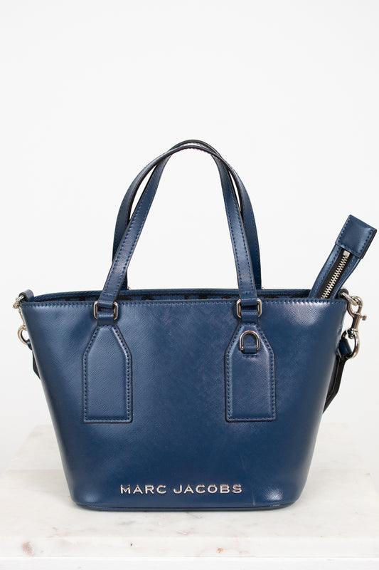 Blue handbag with 'Marc Jacobs' branding on a white background