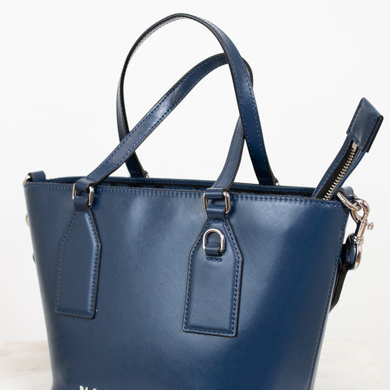 Blue handbag with 'Marc Jacobs' branding on a light background
