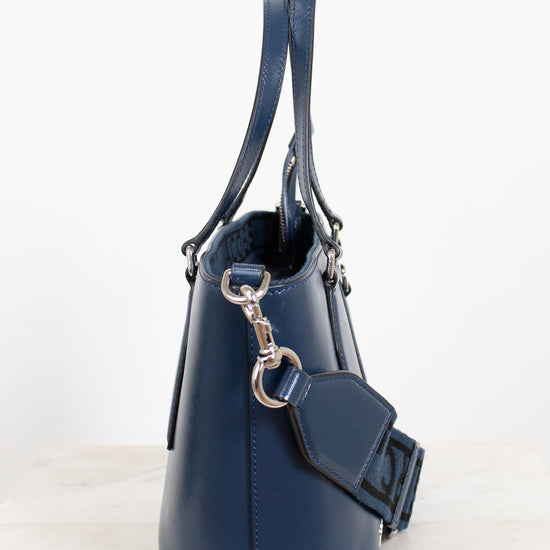 Navy blue handbag with a strap on a white background