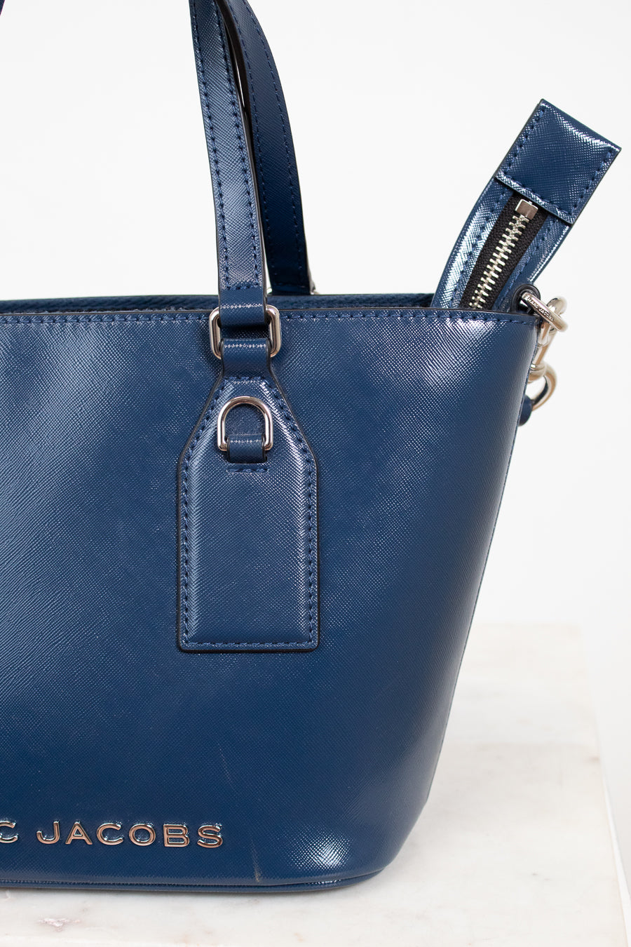 Blue handbag with visible brand name on a white background