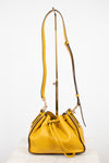 Yellow handbag with a strap on a white background