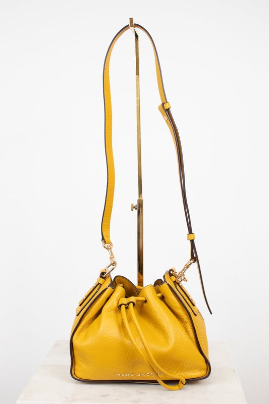 Yellow handbag with a strap on a white background