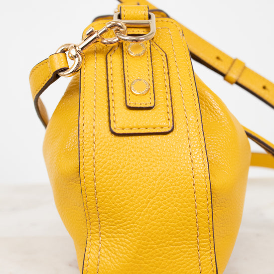 Yellow leather handbag on a light background