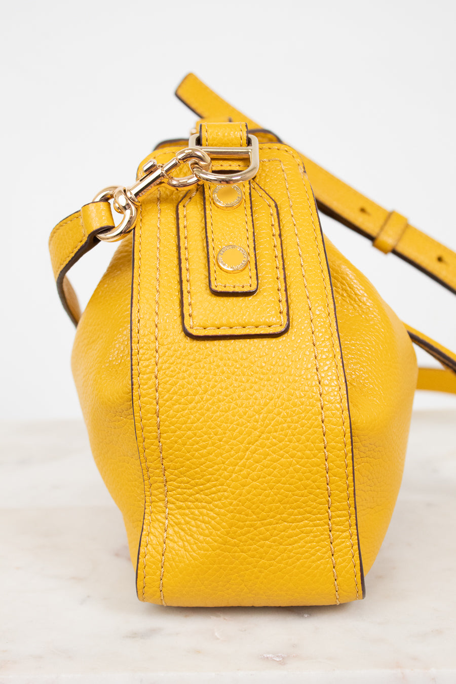 Yellow leather handbag on a light background