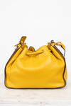 Yellow leather handbag on a white background