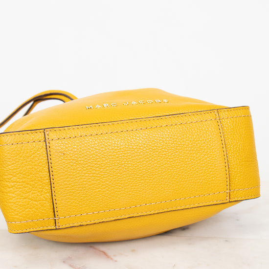 Yellow handbag with brand name on a light background