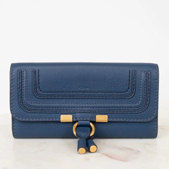Blue wallet with gold accents on a white background
