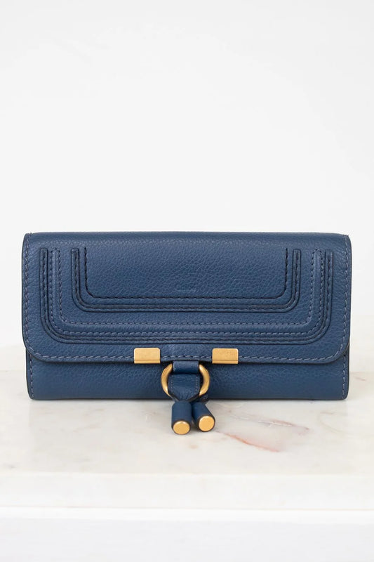 Blue wallet with gold accents on a white background