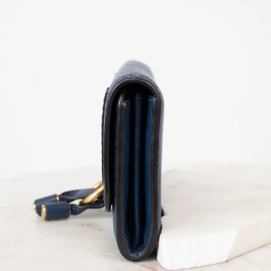 Navy leather Wallet with gold accents on a white background