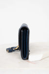 Navy leather Wallet with gold accents on a white background