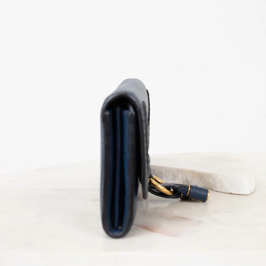 Black climbing chalk bag with strap on a white background
