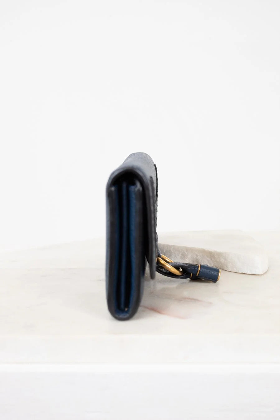 Black climbing chalk bag with strap on a white background