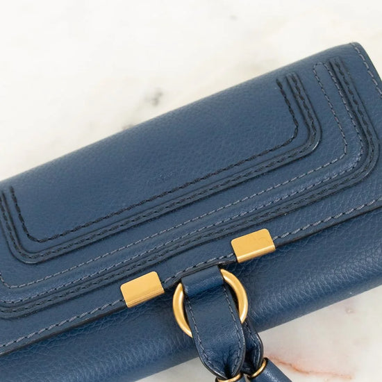Blue wallet with gold accents on a light background