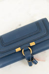Blue wallet with gold accents on a light background