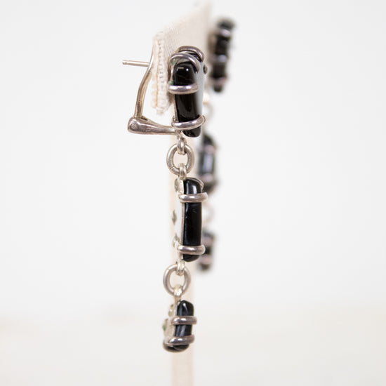 Close-up of a tiered glass earring drop on a white background
