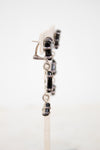 Close-up of a tiered glass earring drop on a white background