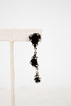 Black glass tiered earrings on a white background