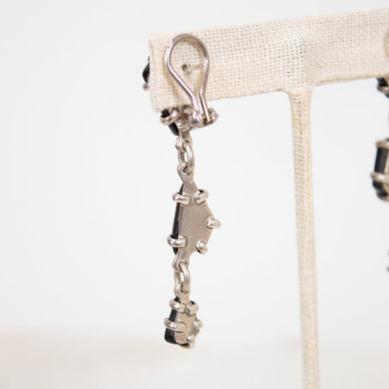 Back of earrings showing silver back on a white background