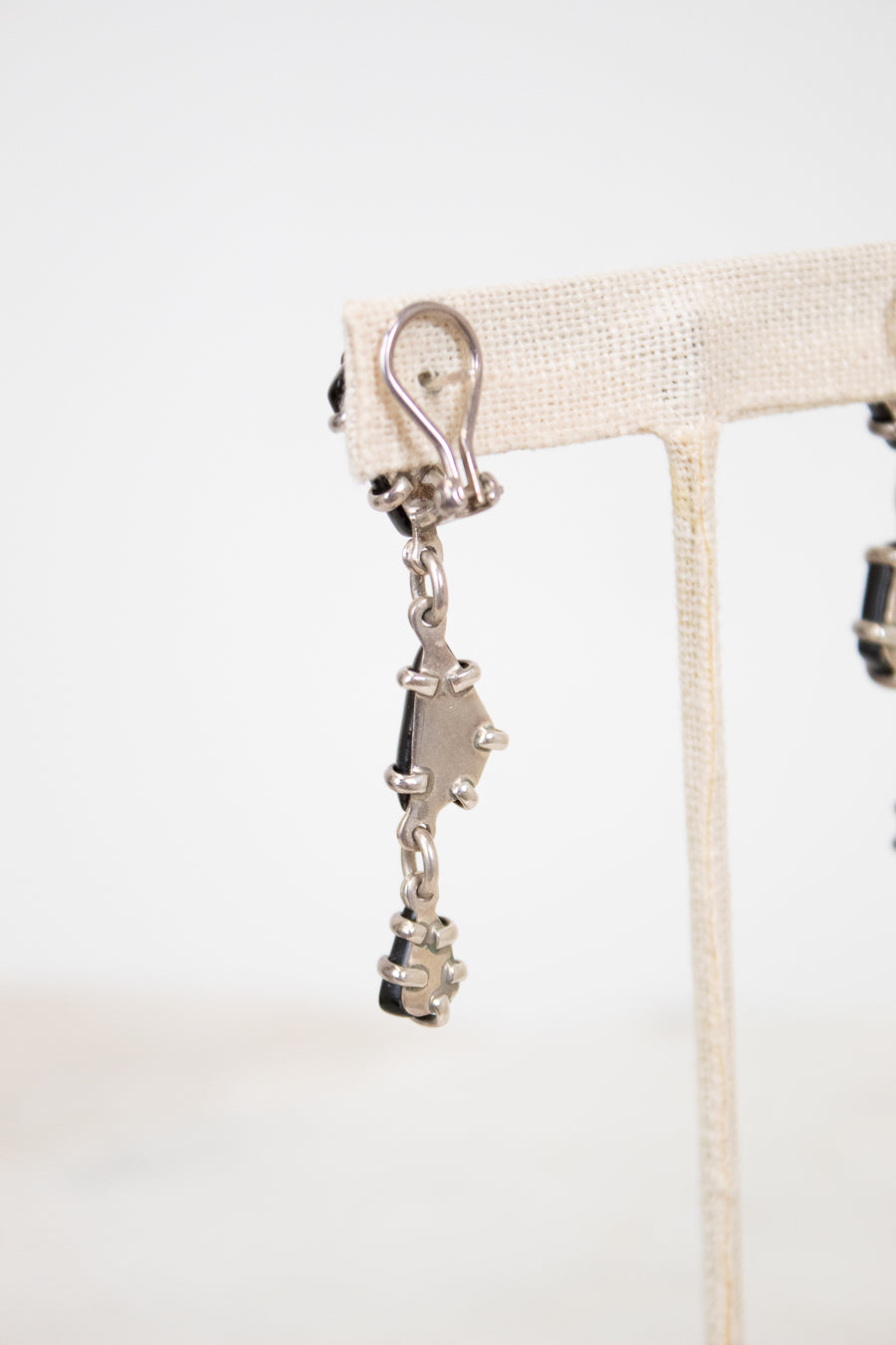 Back of earrings showing silver back on a white background