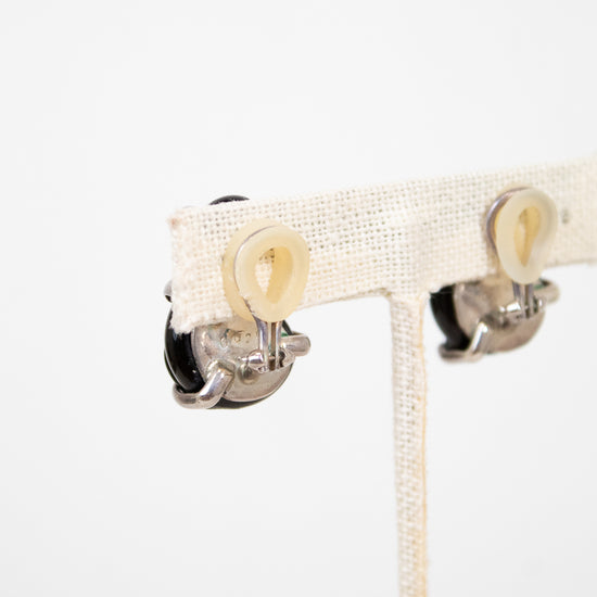 Close-up of backs of clip-on earrings on a white background