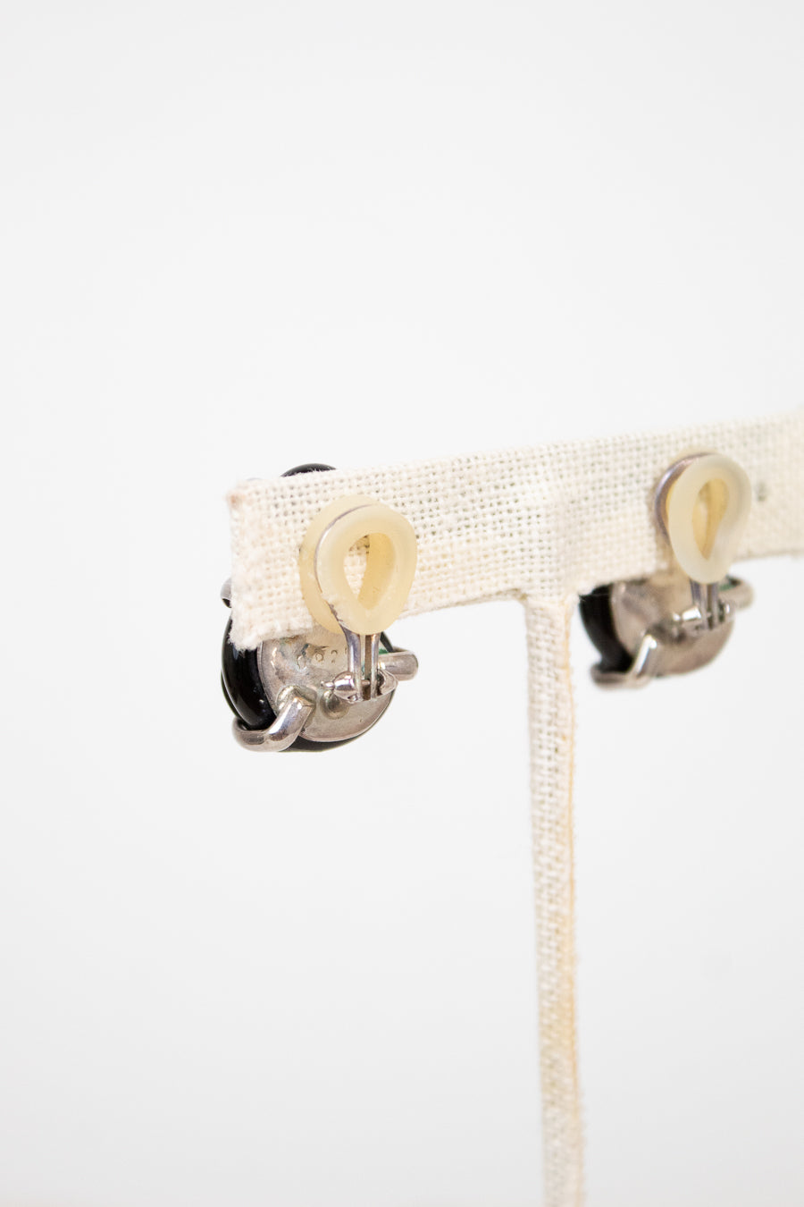 Close-up of backs of clip-on earrings on a white background