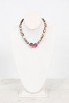 Necklace with mother of pearl beads on a white mannequin bust against a white background