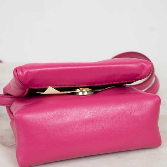 Pink handbag on a light marble surface