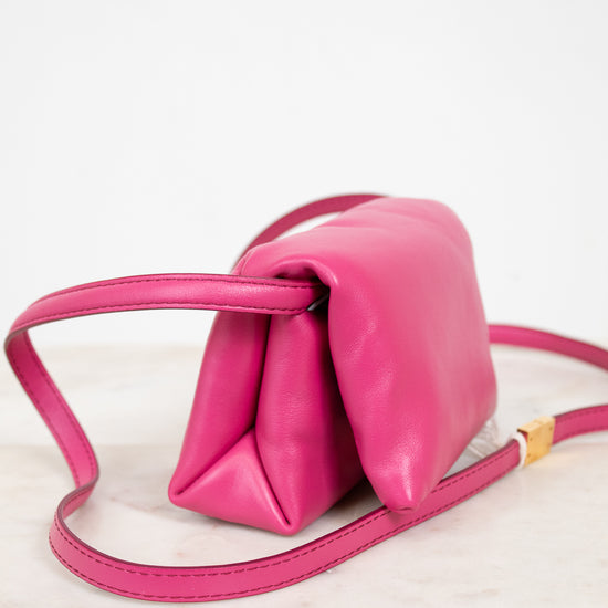 Pink handbag with a strap on a white background