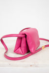 Pink handbag with a strap on a white background