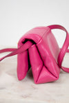 Side of pink handbag on a light background