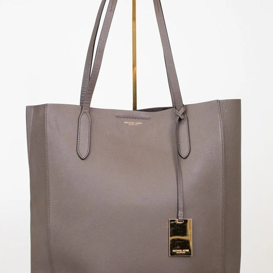 Gray tote bag with a gold clasp on a white background