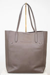Brown tote bag with gold accents on a white background
