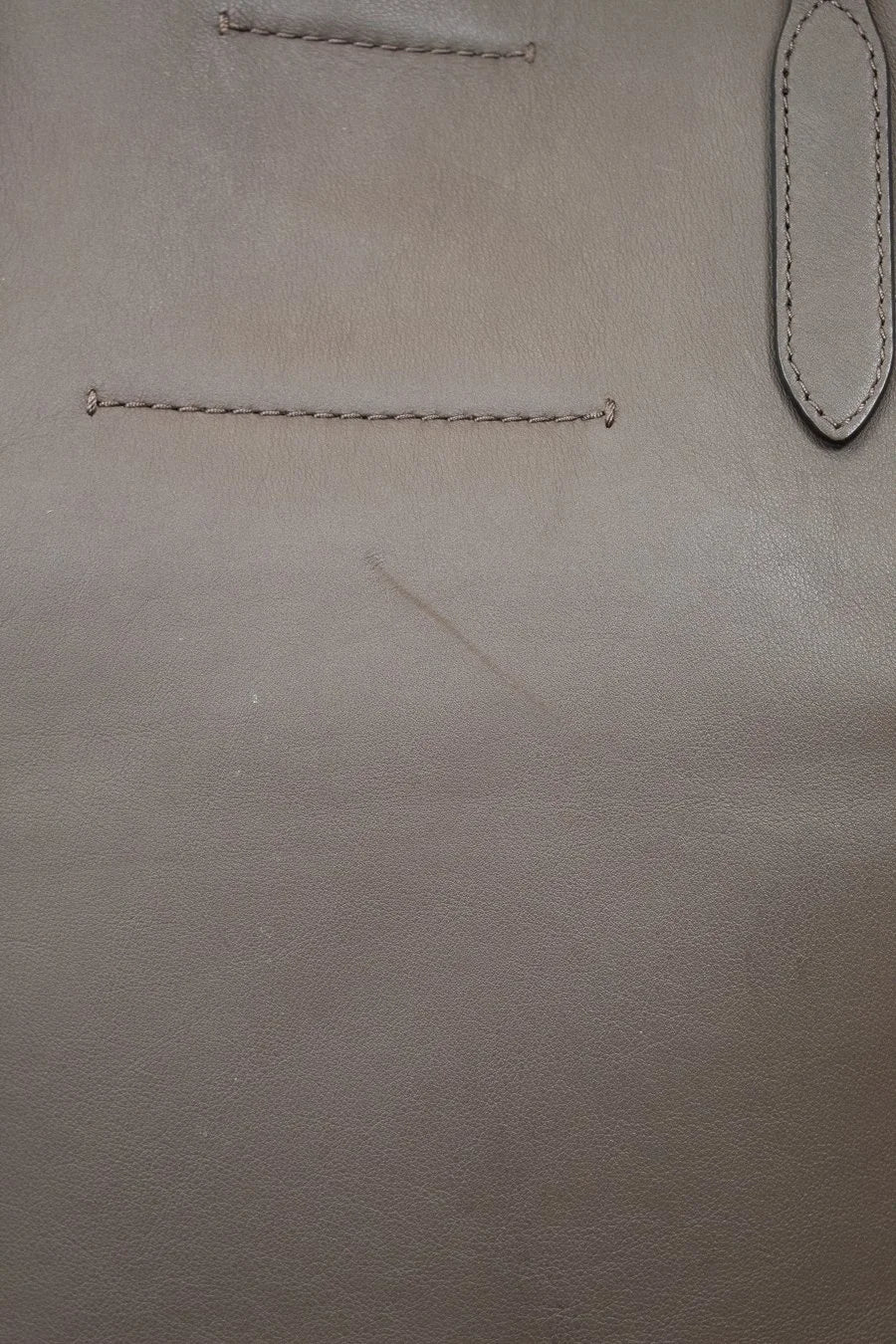 Close-up of brown leather surface with scratch detail