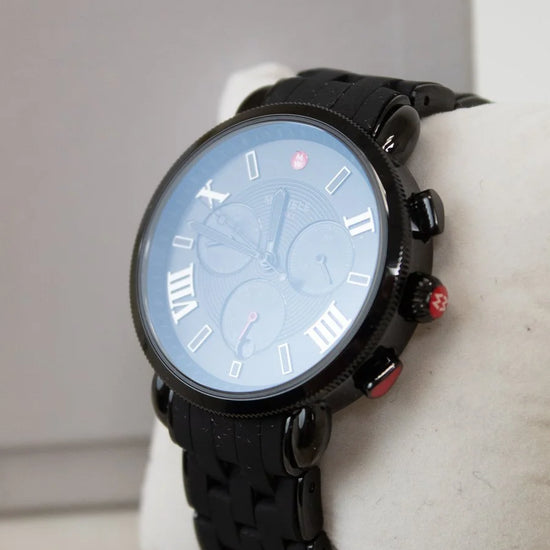 Black wristwatch on a white surface