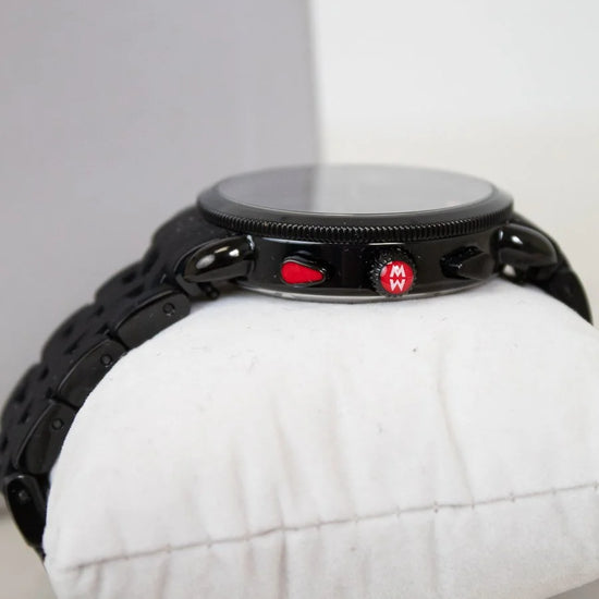 Black watch on a white cushion