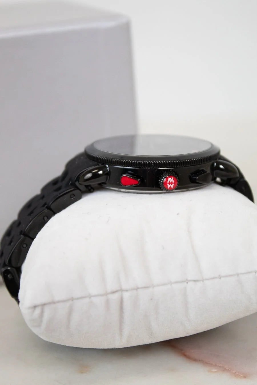 Black watch on a white cushion