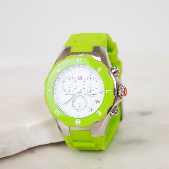 Green watch with a white face on a light background